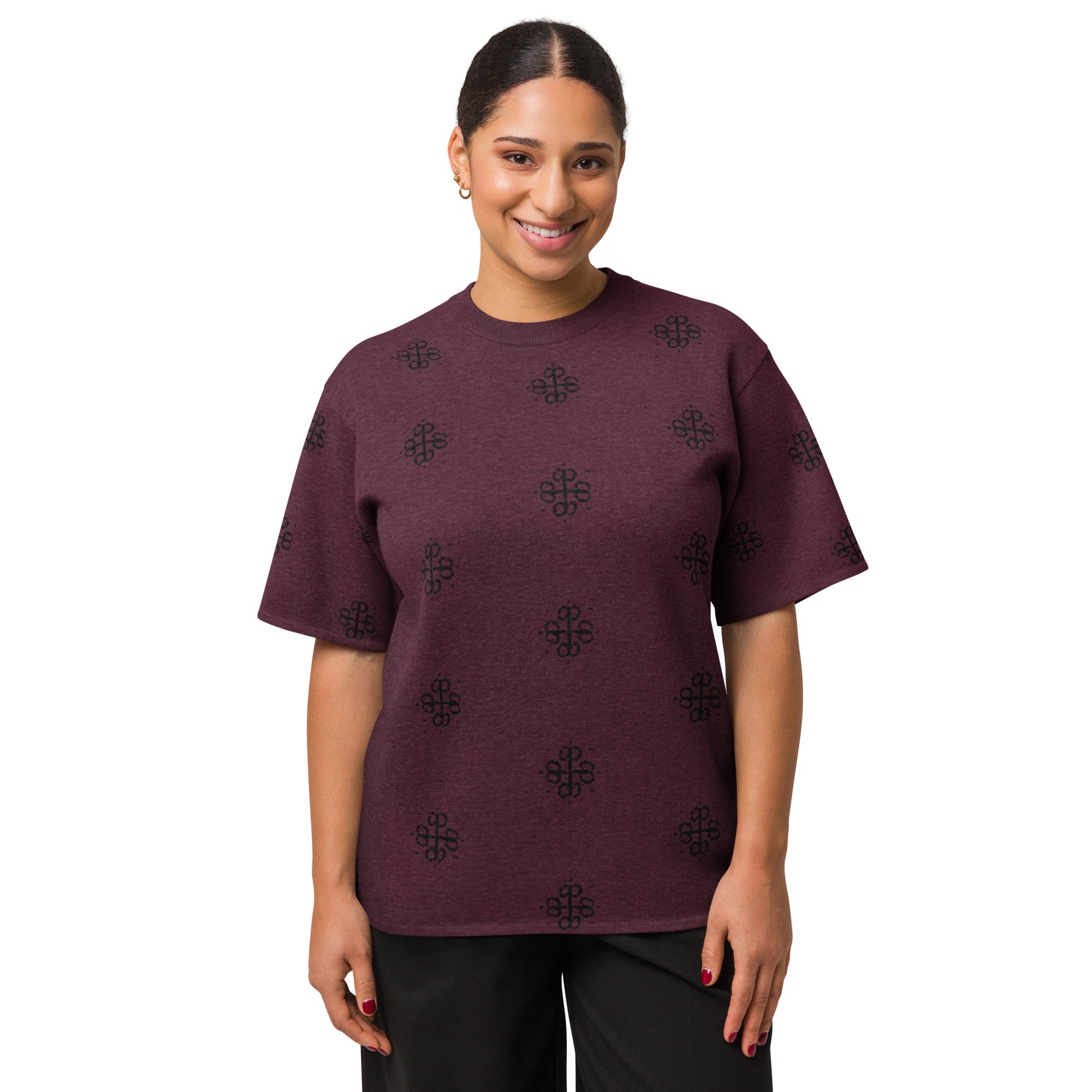 Woman wearing a maroon t-shirt with black geometric patterns on a white background